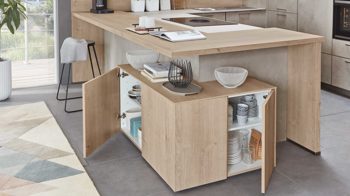 Einbauküche Nobilia® aus Holz in Holzfarben Hell nobilia® Einbauküche Riva mit JUNKER Elektrogeräten und Esstheke Beton Sand & Eiche Montreal - Stellfläche ca. 304 x 319 cm